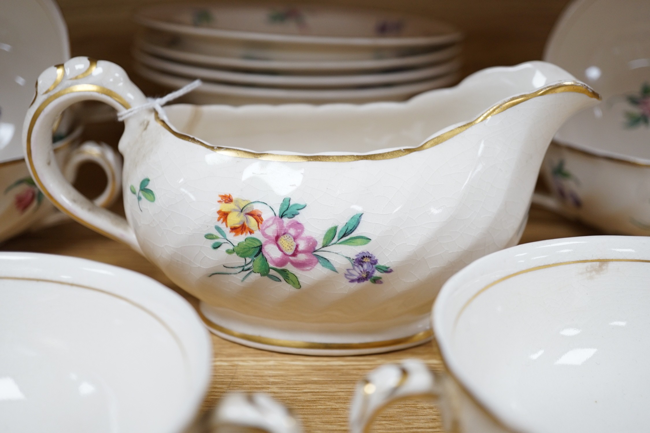 A part Clarice Cliff dinner set. With soup bowls, gravy bowl, etc. with flower decoration